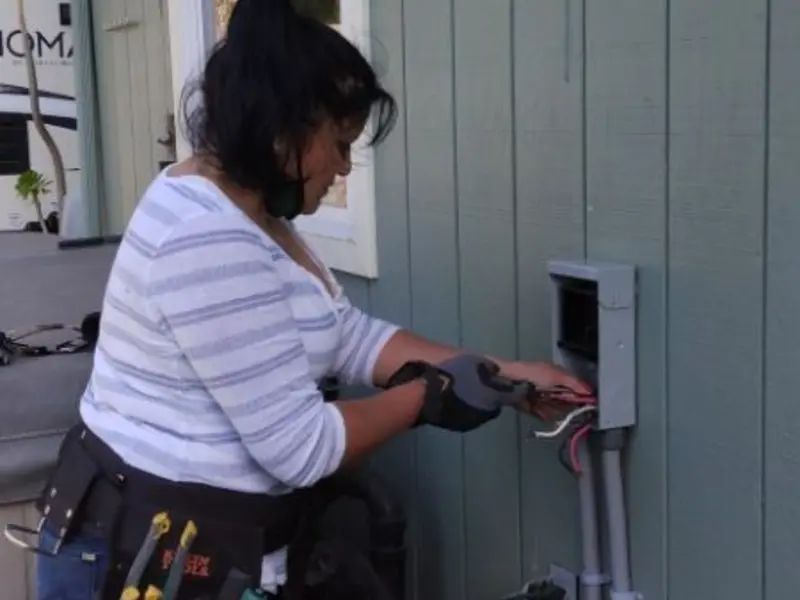 Licensed electrician wiring an exterior subpanel in Firestone
