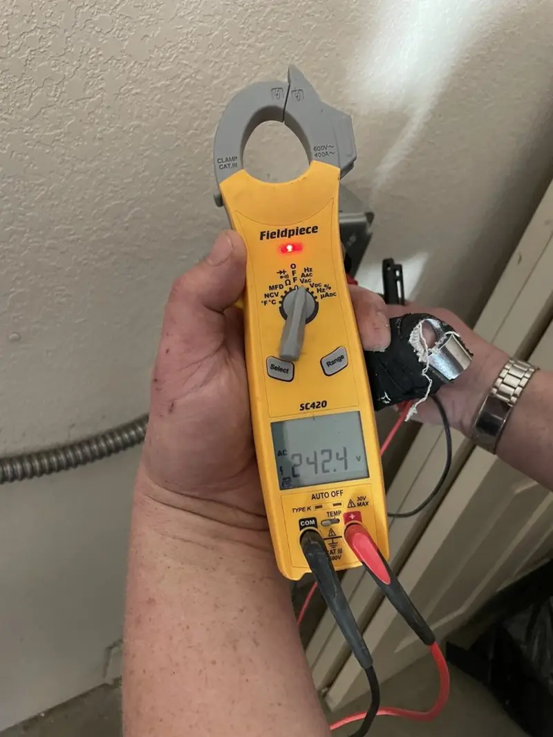 Voltage testing with clamp meter during Ceiling Fan Installation in Firestone